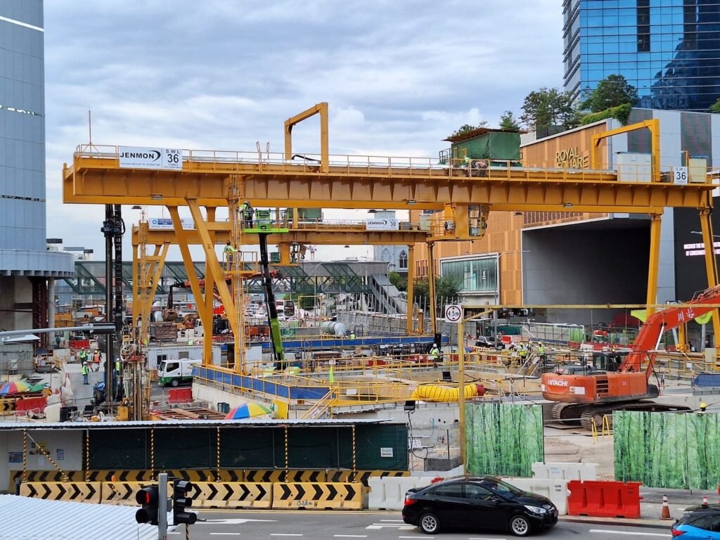 Huge Crane in a Construction site along a busy road