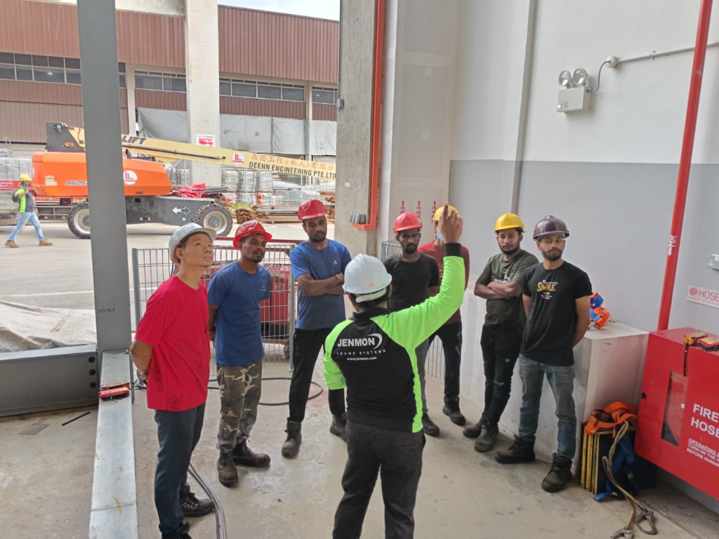A group of crane operators listening to an instructor
