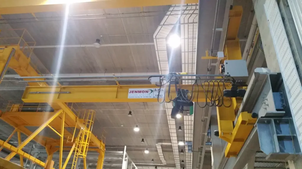 A wall jib crane is used for lifting equipment inside a warehouse
