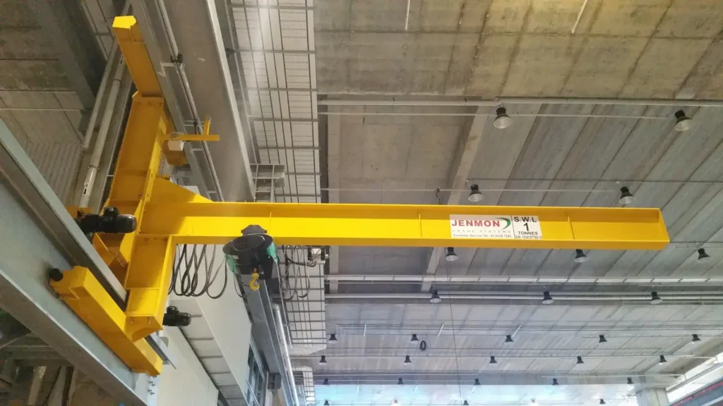 A crane is installed on the wall with a hoist attached to it