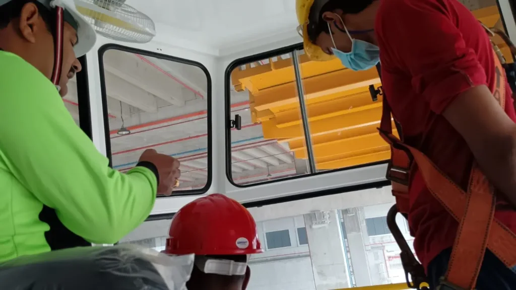 A crane trainer helping an operator understand the basic hands-on practical test